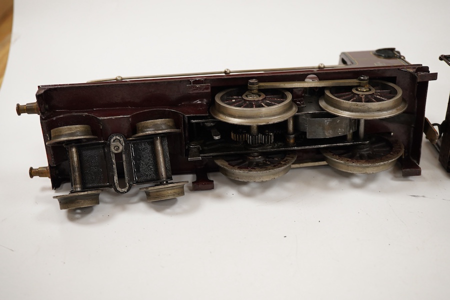 An 0 gauge Bing clockwork tinplate Midland Railway 4-4-0 tender locomotive, 999, in maroon livery with yellow and black lining and original clockwork mechanism